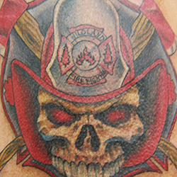 Tattoo of skull with firefighters helmet