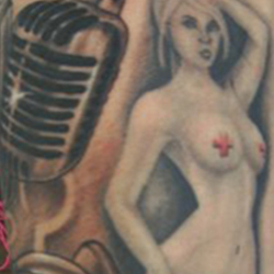 Tattoo of hourglass and microphone