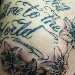 Tattoo of text with flowers