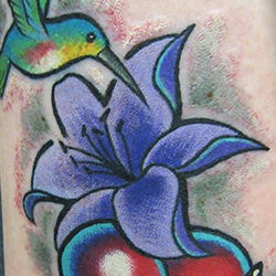 Tattoo of bird and flower